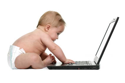 Baby typing on a laptop keyboard